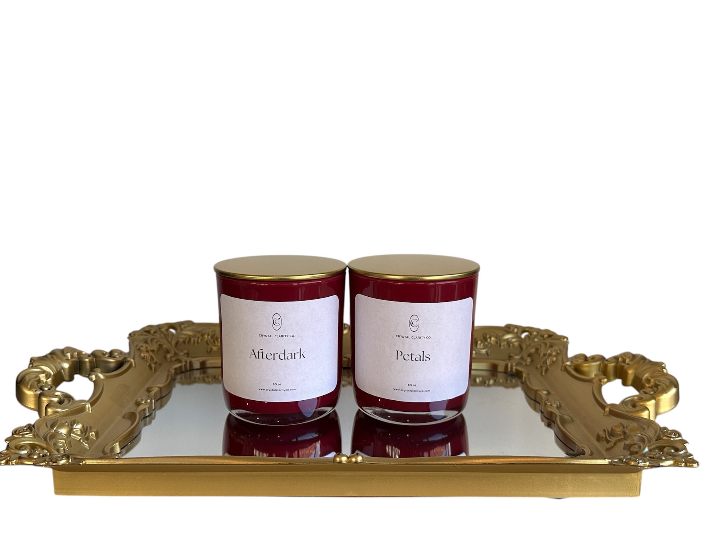 2 candles "Afterdark" and "Petals" displayed on a gold mirror tray
